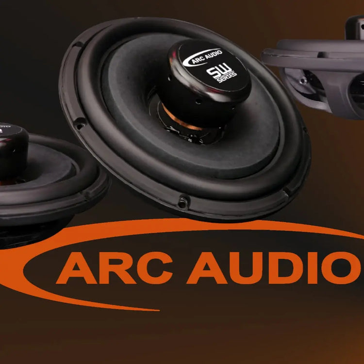 Car speakers with ARC Audio branding on a dark background