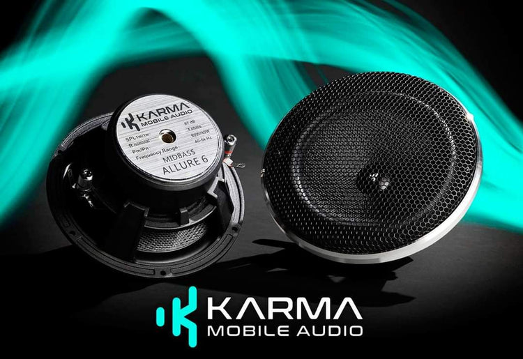 Two Karma Mobile Audio speakers with a vibrant green background