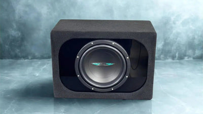 Subwoofer in a black enclosure on a gray background