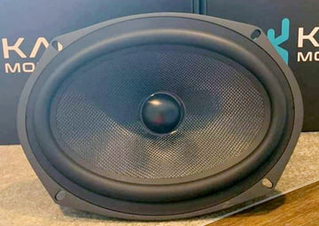Speaker with Kicker logo in the background