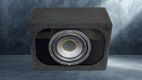 Car subwoofer in a black enclosure on a gray background