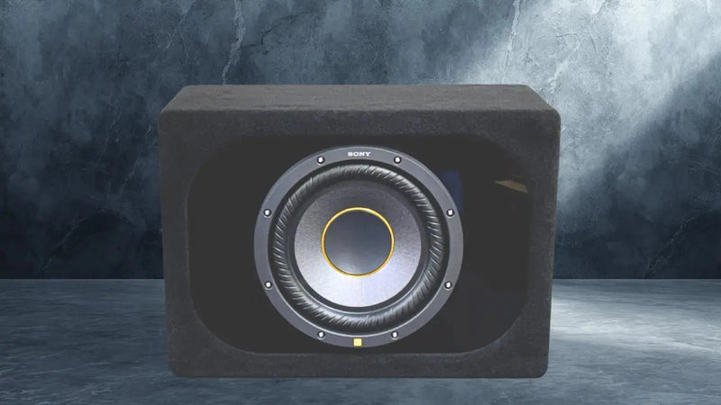Black subwoofer with visible brand logo on a dark background