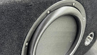 Close-up of a car subwoofer in a black enclosure