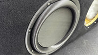 Close-up of a car speaker with a focus on the cone and frame.