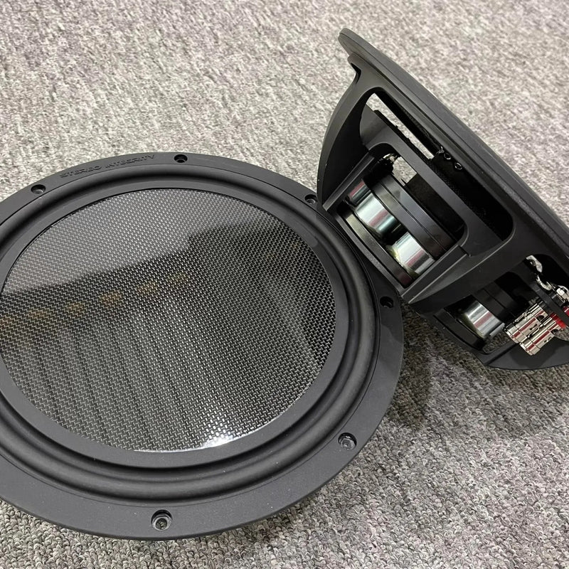 Stereo Integrity BM-11 shallow subwoofers, one showing the flat carbon fiber piston and one showing the side profile