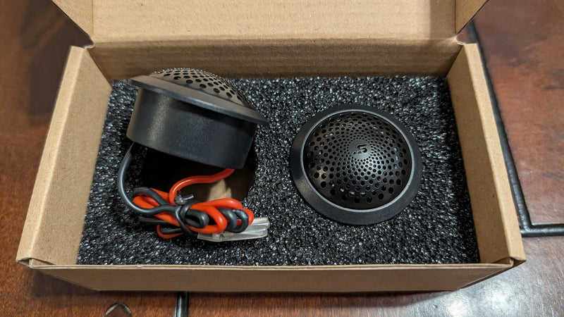 Stereo Integrity M22 tweeter pair in the box, showing front and rear