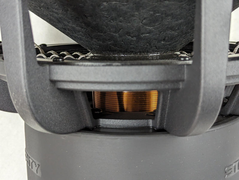 Stereo Integrity SQL series close-up through the basket window showing the copper voice coil