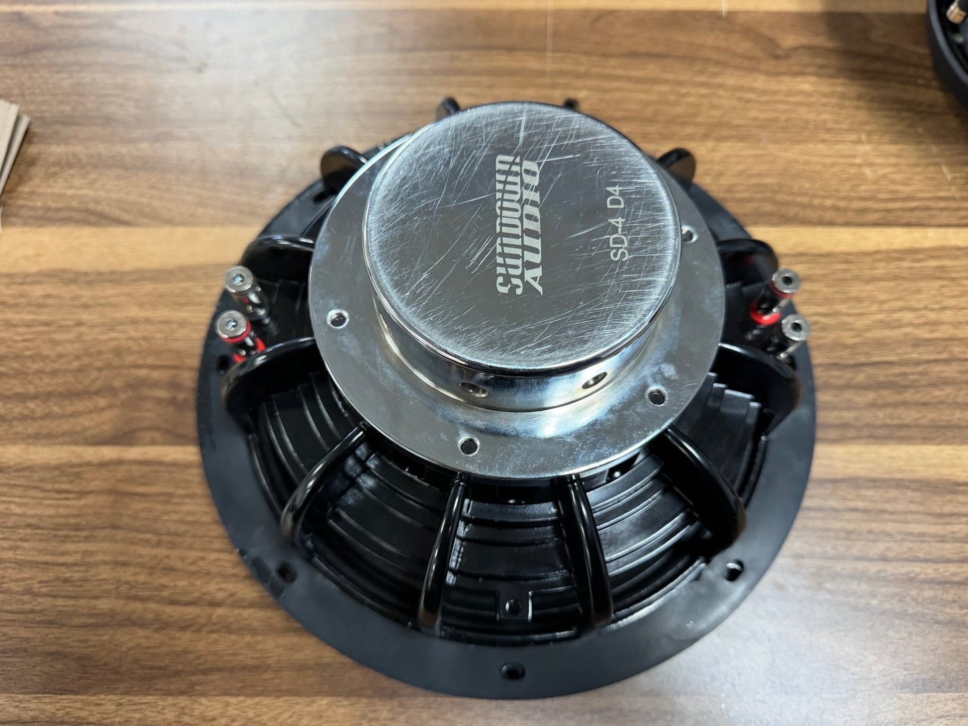 Speaker on a wooden surface with 'Shunwoo Audio' branding.